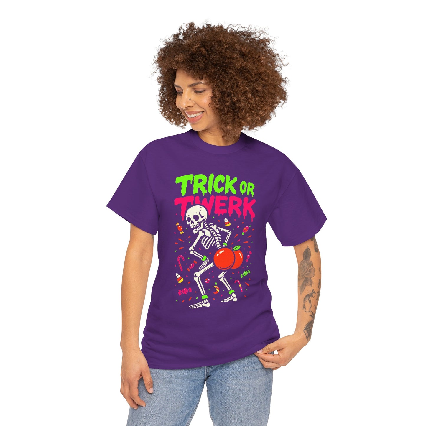 Woman wearing a purple 'Trick or Twerk' Halloween t-shirt with a skeleton and candy design.
